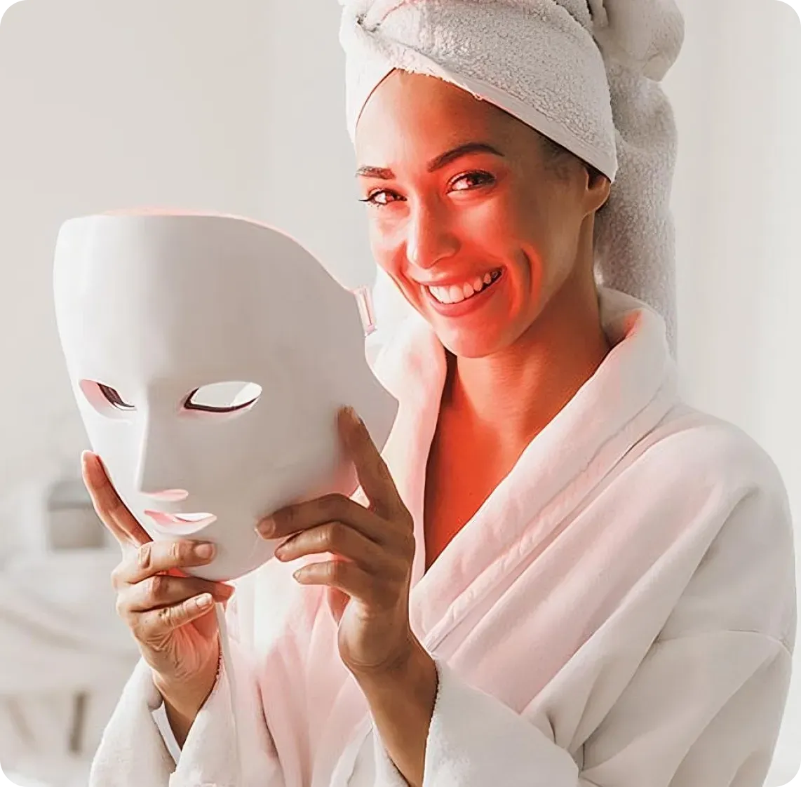 Woman using Glokore LED light therapy mask at home